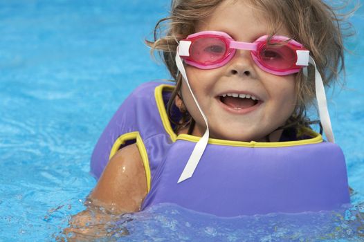 a young girl playing in pool