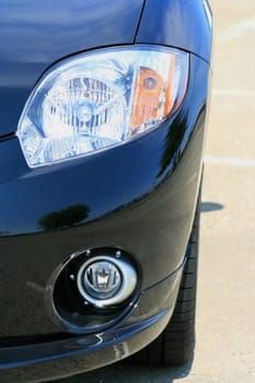 Close up of the headlights of a sports car.
