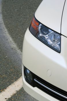 Close up of the headlights of a sports car.
