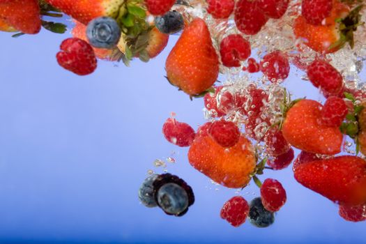 Fruit splashing in water background - shallow depth of field