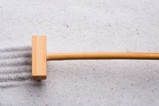 A small rake, creating a design in a zen garden
