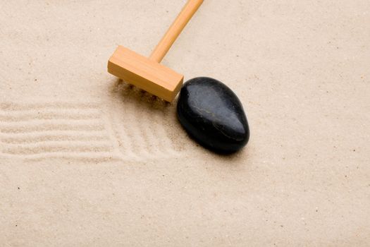 A small rake, creating a design in a zen garden