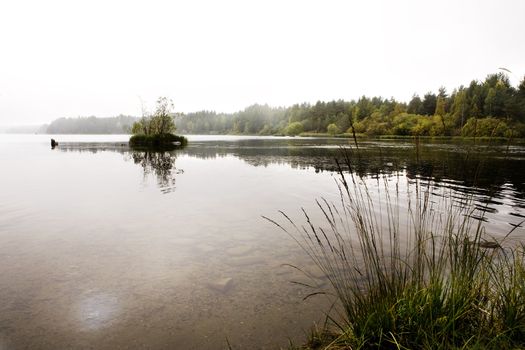 A quiet calm lake with fog