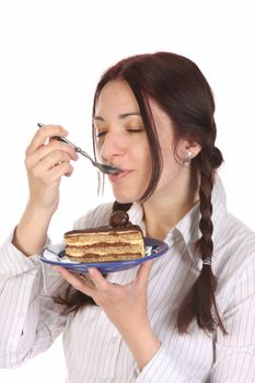 Beautiful woman eating piece of cake on white background