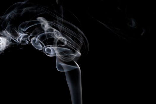 A stream of smoke on a black background