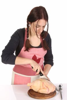 beautiful housewife cutting chicken on white background