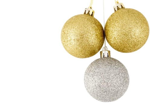 Three christmas balls, two golden, one silver