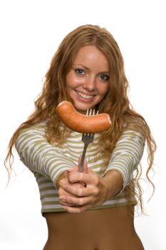 red-haired girl eating a sausage on a light background