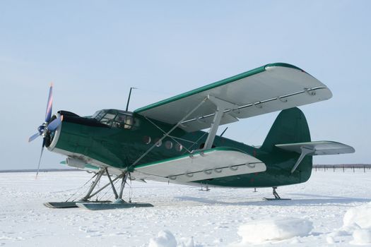 plane with skis on a  the snow (AN-2)