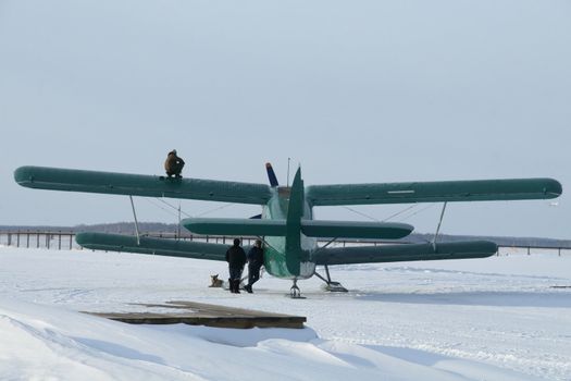 plane with skis on a  the snow (AN-2)