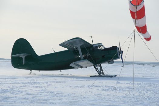 plane with skis on a  the snow (AN-2)