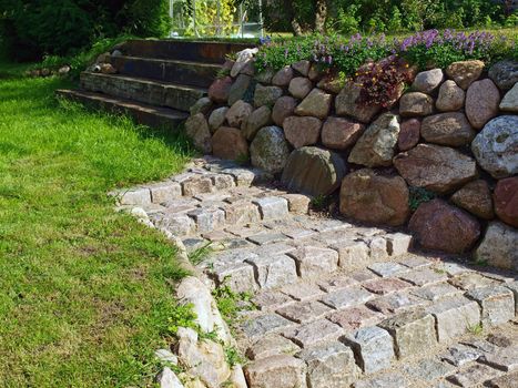 Stone walkway path and stairs in a beautiful garden       
