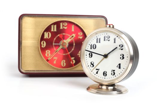 old alarm clock with gold trim on a white background