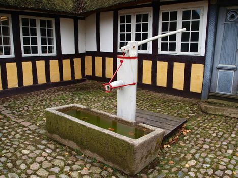 Old vintage well water pump in village Denmark   
