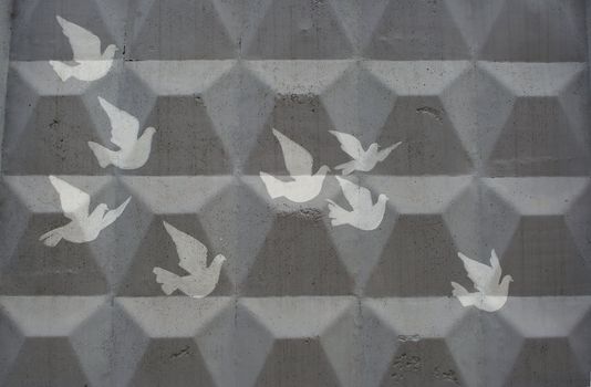 cliche drawing of doves on a grey concrete wall