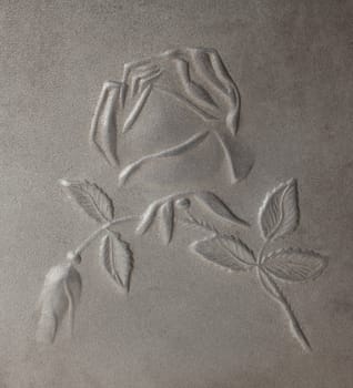bas-relief depicting roses on the metal