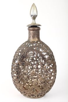 antique bottle chained to the metal with the dragon is depicted