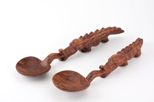 a carved spoon in the shape of a crocodile