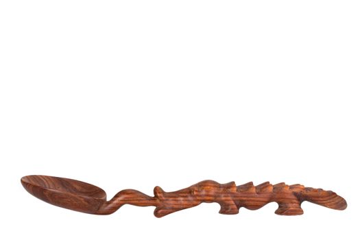 a carved spoon in the shape of a crocodile