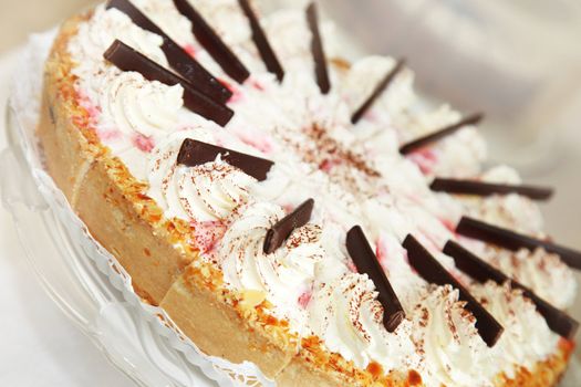 Cream-strawberry cake decorated richly