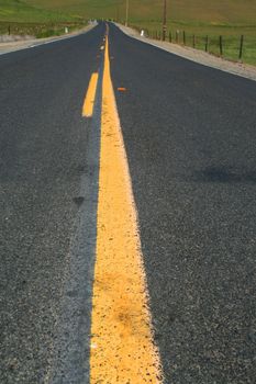 Long infinite road on a sunny day.
