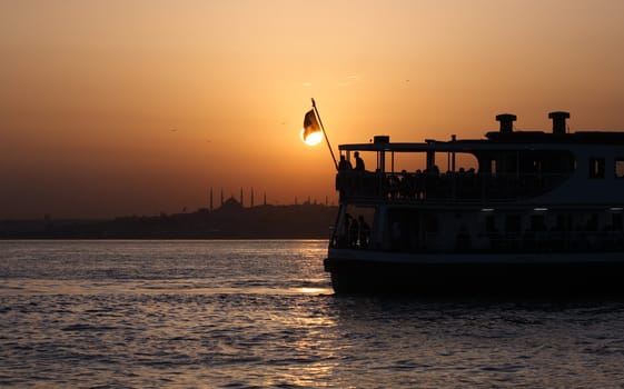 Passenger Ferry sailing across Bosporus during sunset. Istanbul, Turkey