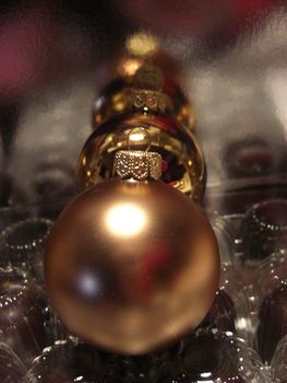 golden christmas baubles forming a line