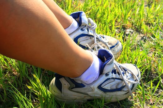 Close up of woman's feet with sneakers on.

