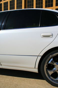 White Lexus GS with chrome rims and tinted windows.
