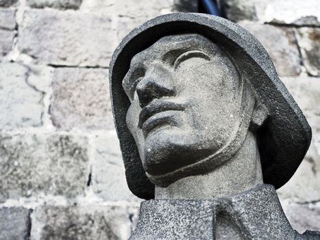 Stone head of old monument in Barcelona war museum