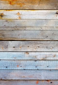 The weathered wall is covered with wooden planks