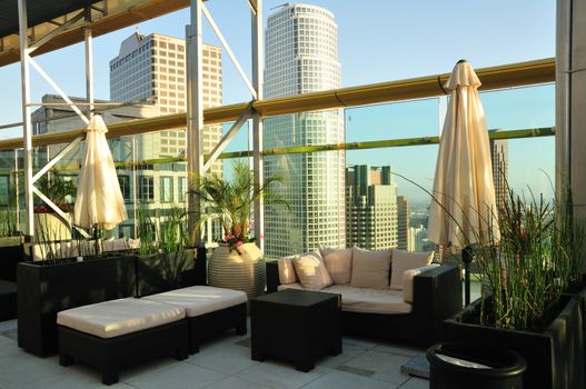 Rooftop seating area with a skyscraper sunset view