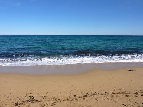 Waves of the blue mediterranean sea on a sand beach, France, by beautiful weather