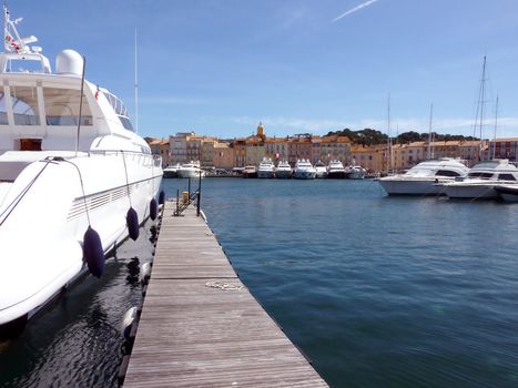 Yachts and pontoon at the port of Saint-Tropez, France, by beautiful weather