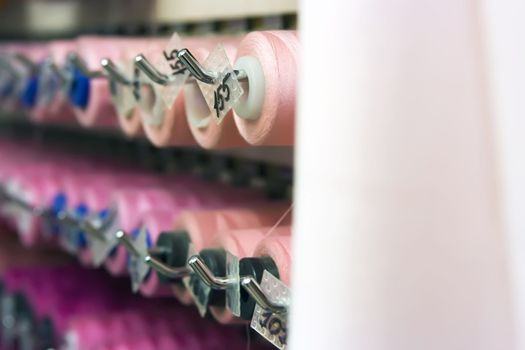 A lot of thread spools attached to a wall
