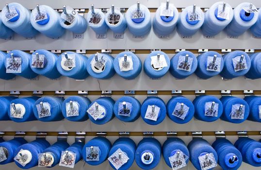 A lot of thread spools attached to a wall