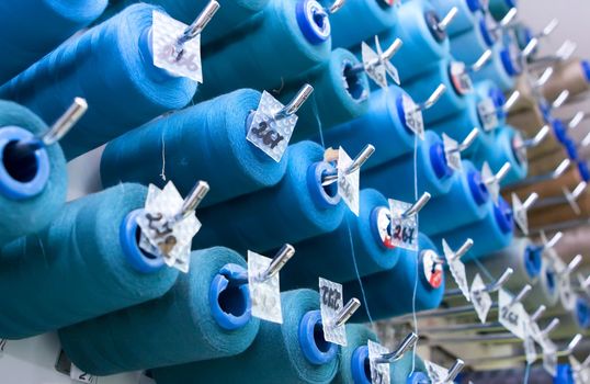 A lot of thread spools attached to a wall