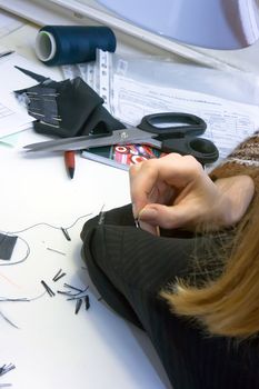 Tailor repairing clothes with needle and threads