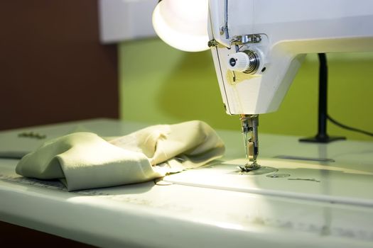 A sewing machine and thread spool on a table