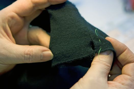 Stich on a torn sweater