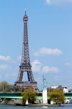 Statue of liberty on the river Seine and Eiffel tower in Paris, France, Europe