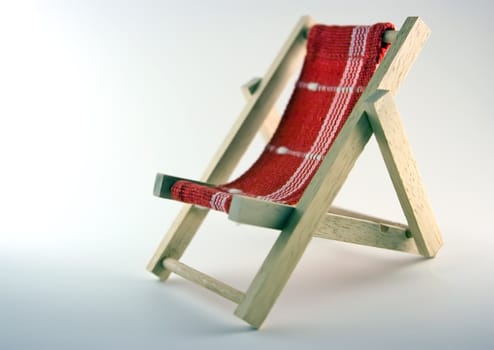 Toy chaise longue on white background