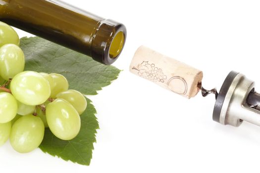 Corkscrew with wine cork, bottle and grapes on white background