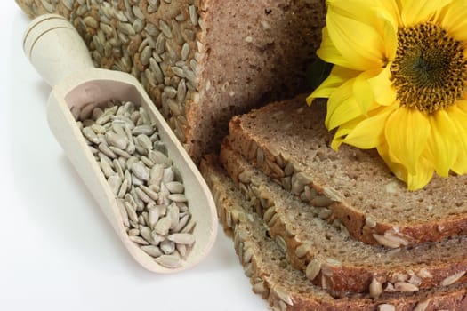 Sliced multigrain bread with sunflower seeds and sunflower blossom