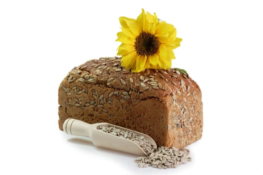 Loaf of multi-grain-bread with sunflower blossom on white background