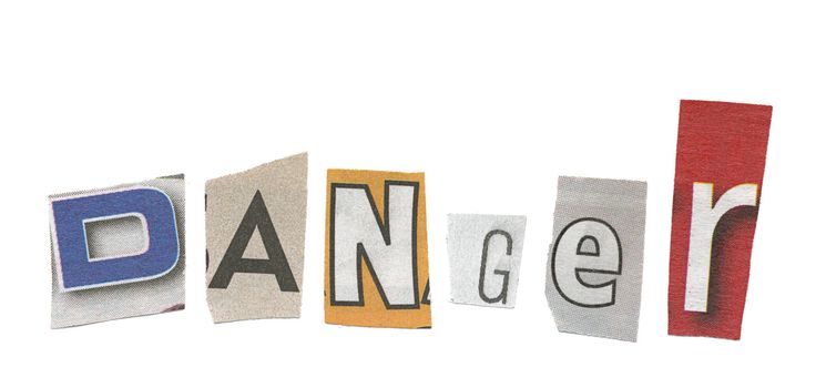 The word danger is spelled out using cut up magazine letters, isolated against a white background.