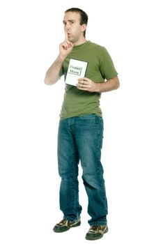 A young man dressed in casual clothing is holding a pirated movie and saying shhh, isolated against a white background.