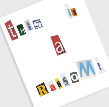 A mysterious ransom note spelled with cut up magazine letters.