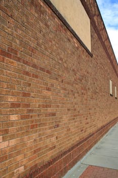 Brickwall over blue sky showing unique pattern.
