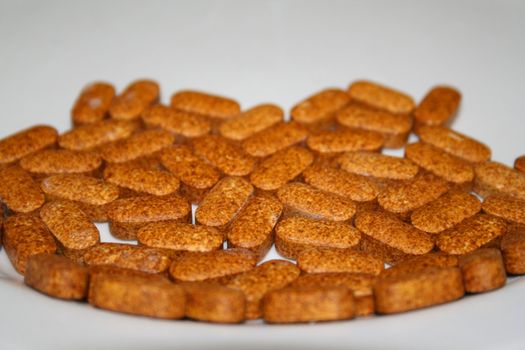 Close up of pills on a white background.
